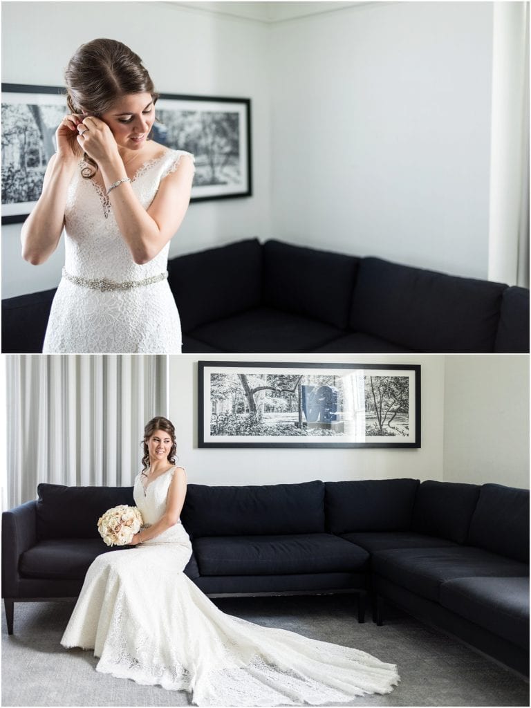 Bride putting her earrings on and sitting for a bridal portrait in hotel suite