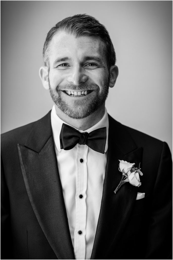 black and white portrait of groom on his wedding day