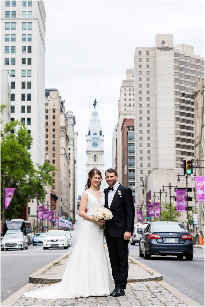 Bride and groom portrait in front of City Hall on Broad Street in Philadelphia