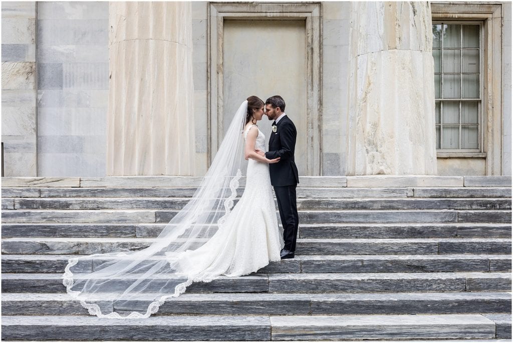 Portrait of bride and groom on the marble stairs of the Second National Bank