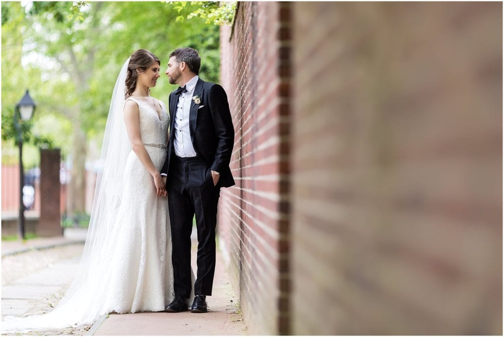 Bride and groom looking at each other in a portrait that utilizes leading lines