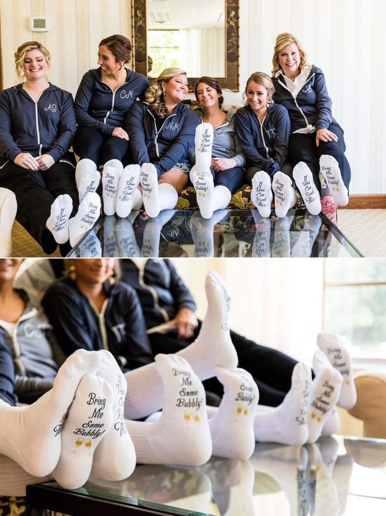 Bride hanging out with bridesmaids in matching socks and robes | Ashley Gerrity Photography www.ashleygerrityphotography.com