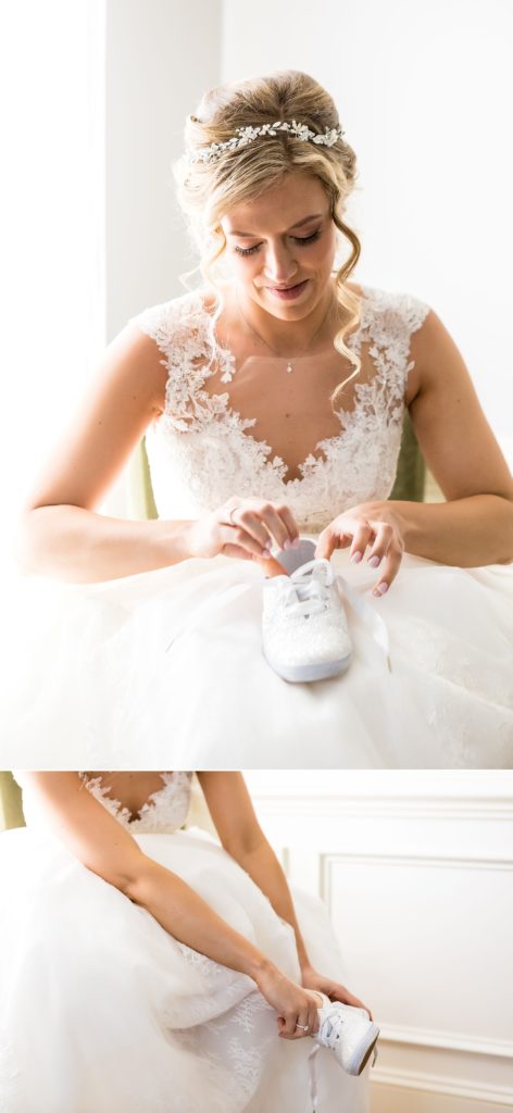 Bride putting on her Kate Spade x Keds bridal shoes | Ashley Gerrity Photography www.ashleygerrityphotography.com
