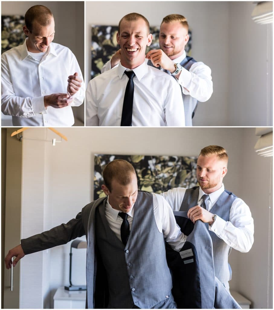 groom getting ready before wedding with help from groomsmen