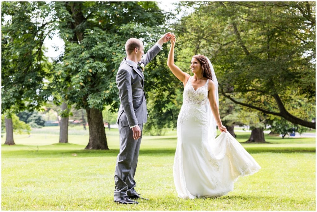 groom spinning bride around in her dress