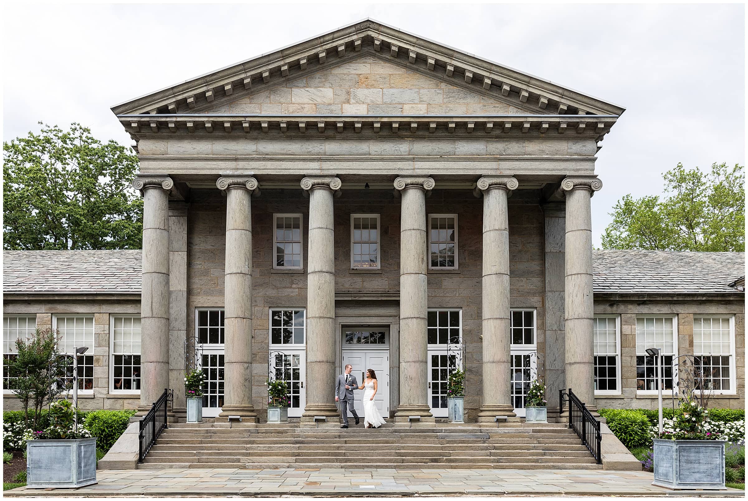 bride and groom portrait walking down steps at Ballroom at Ellis Preserve