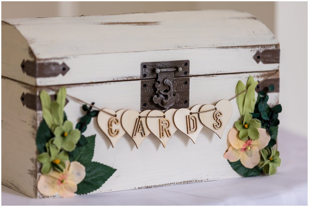 wedding reception detail of romantic card box with matching florals