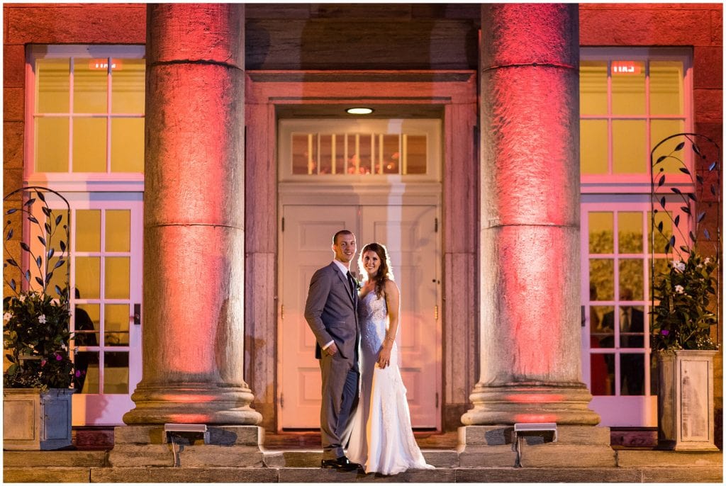 bride and groom night portrait with pink lighting outside Ballroom at Ellis Preserve