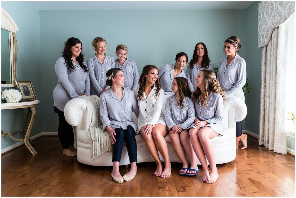 traditional bridal party laughing portrait with matching pajama shirts