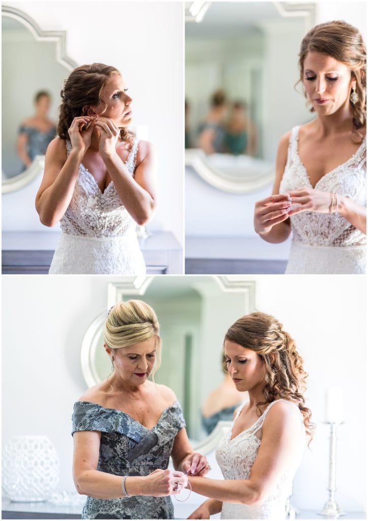 bride putting on her jewelry with moms help portraits