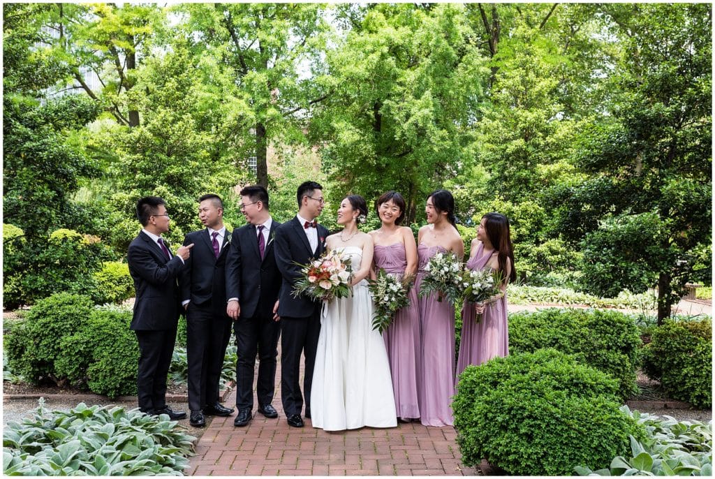 bridal party laughing in garden with lavender color palette