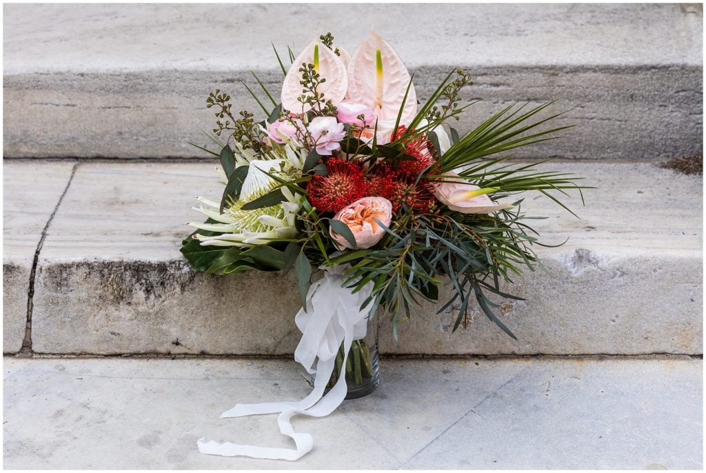 Gorgeous bouquet from Robertson's Flowers featuring palm greens, peace lilies, and tropical flowers