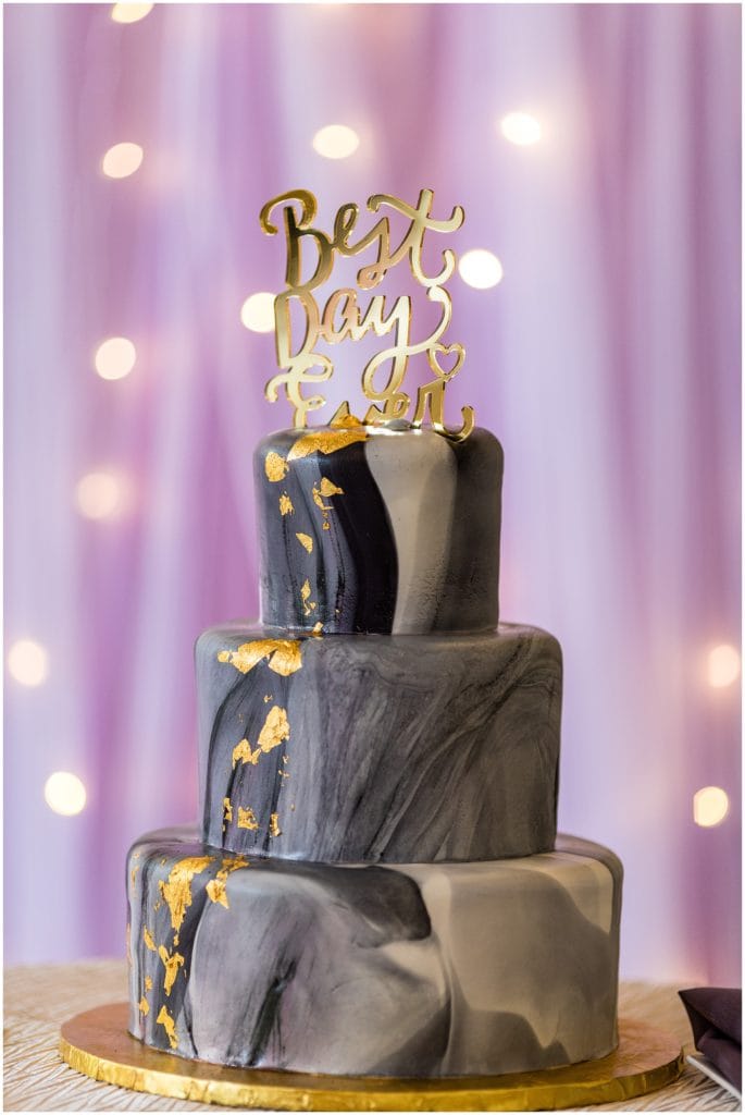 black and white marble wedding cake with gold leaf and "best day ever" cake topper