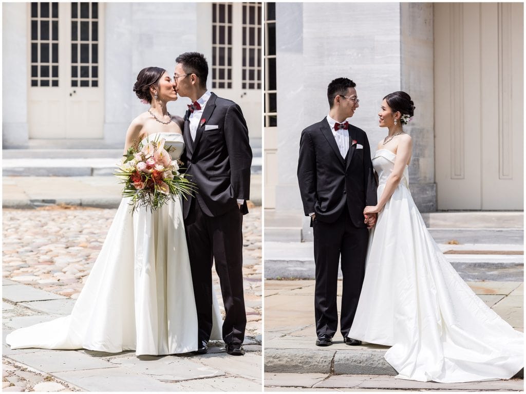bride and groom kissing outside in front of marble background