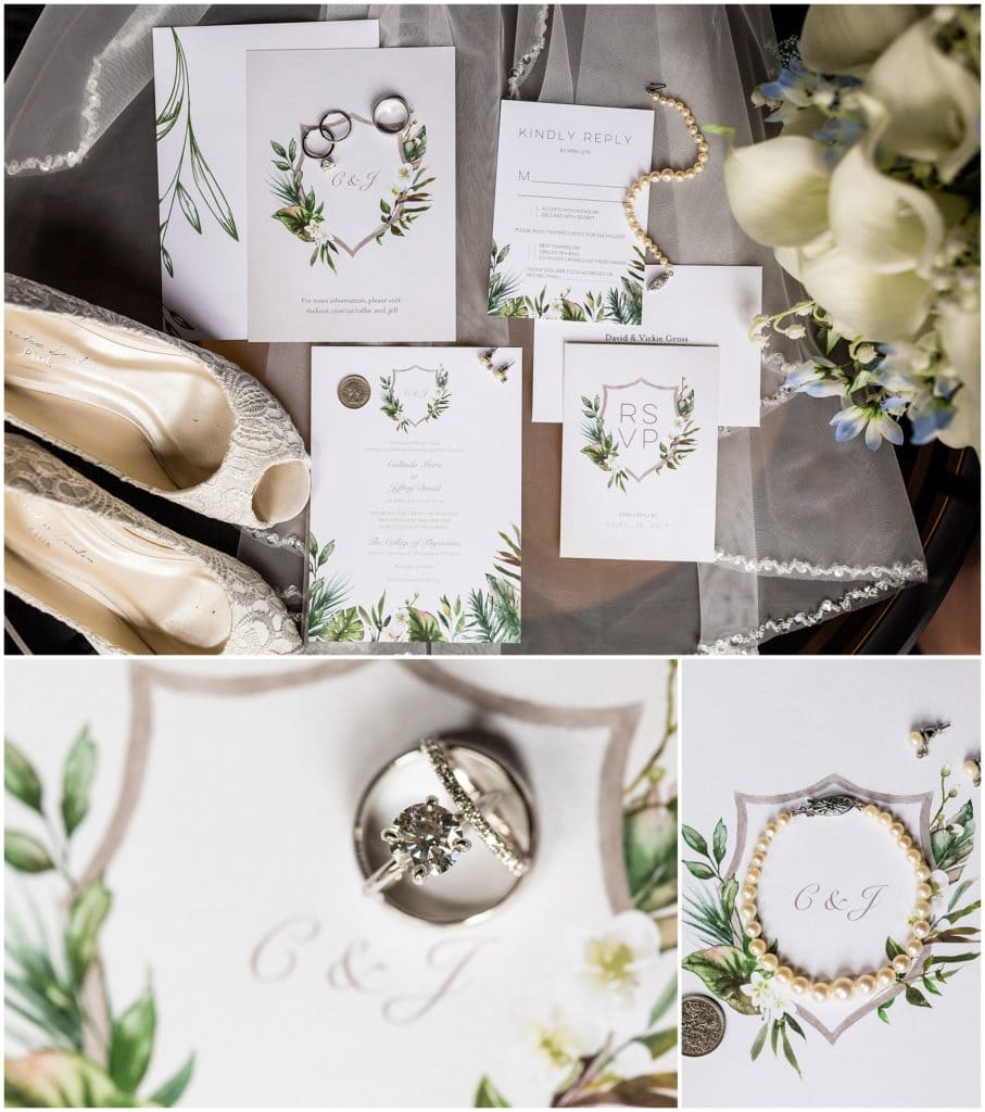 Details of invitation suite featuring watercolor greens, bride's vintage pearl bracelet, wedding rings, and faux florals