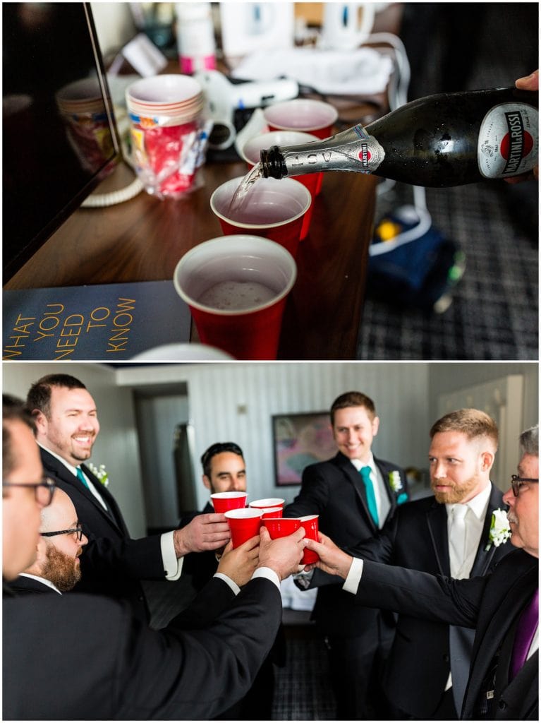 Champagne being poured into red solo cups and groom and groomsmen raising a toast to the groom