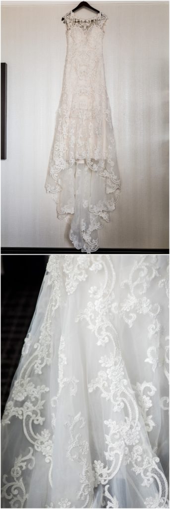 Brides wedding dress hanging from custom hanger, detail of lace skirt of wedding dress