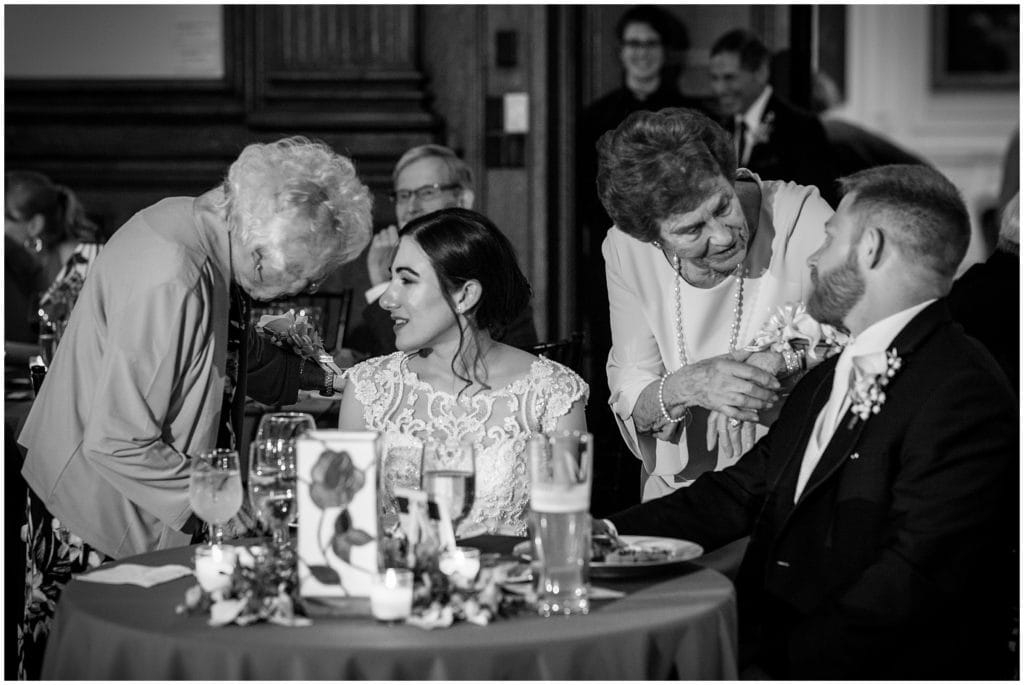 Grandmothers visiting the bride and grooms table to talk during their College of Physicians reception