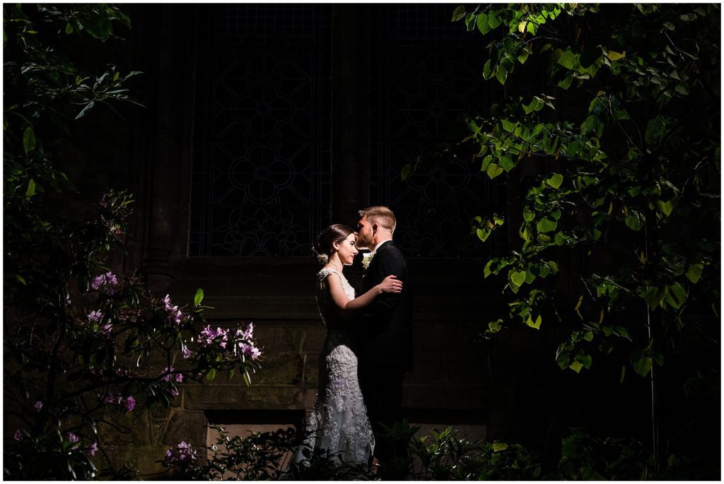 Dramatic nighttime portrait of bride and groom in the courtyard of the College of Physicians