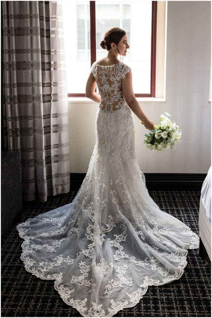 full length portrait of bride in her Maggie Sottero wedding dress with her bouquet at her side