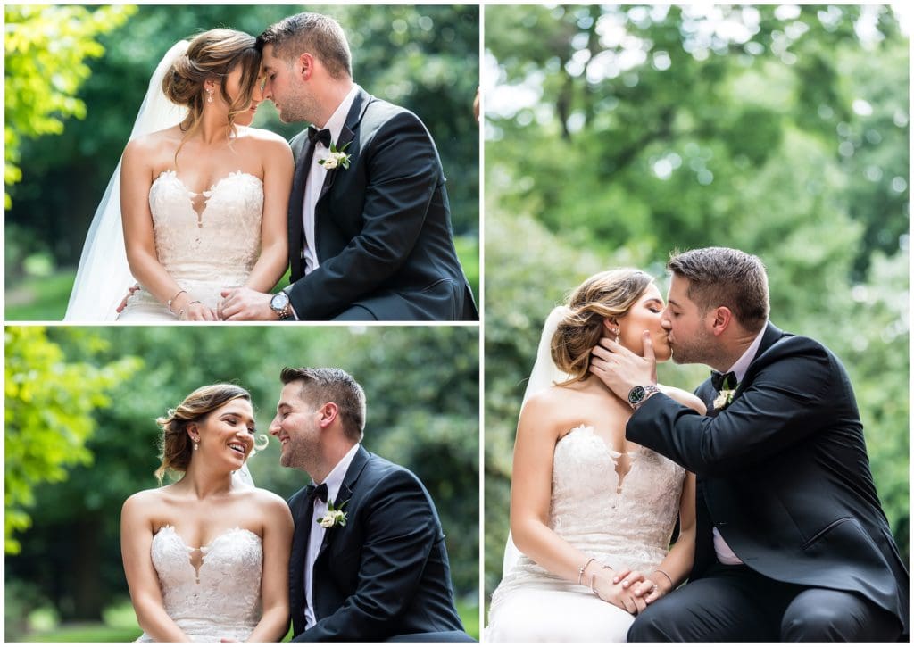 Romantic outdoor portraits of bride and groom sitting on a brick wall in front of greenery