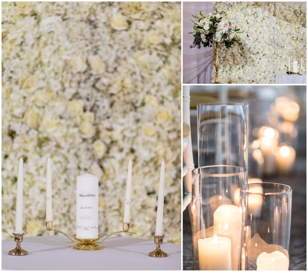 Ceremony details of unity candle, flower wall, and candles at the Lucy by Cescaphe