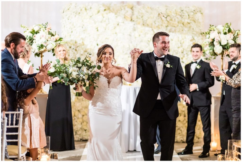 Bride and groom celebrating their marriage walking up aisle