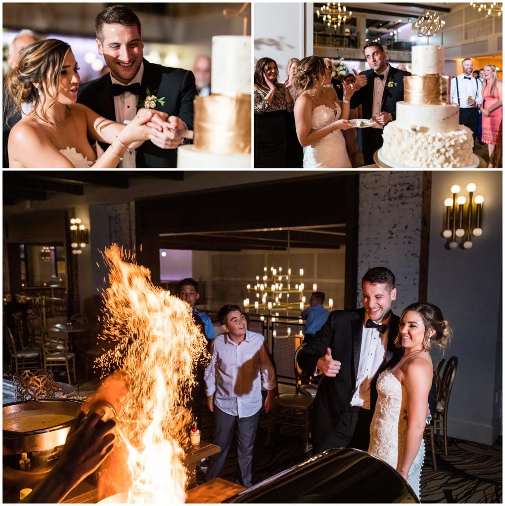 bride and groom cutting wedding cake and watching flames at cooking station action shot