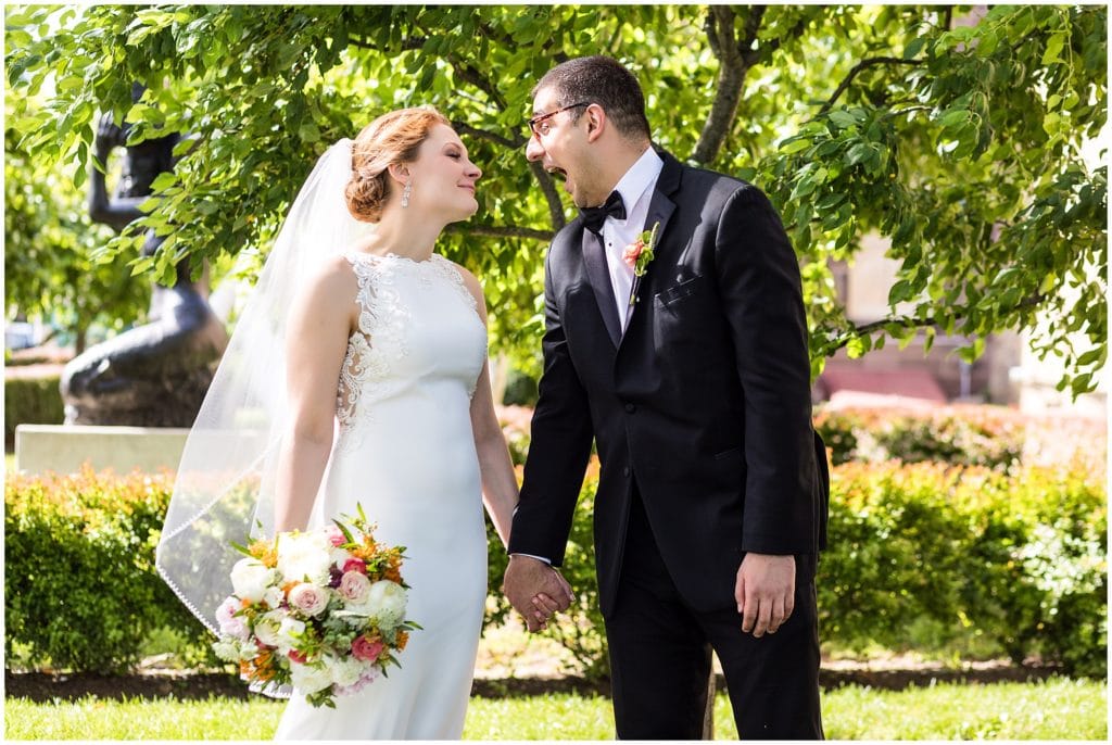 Groom making face at his bride during outdoor portraits