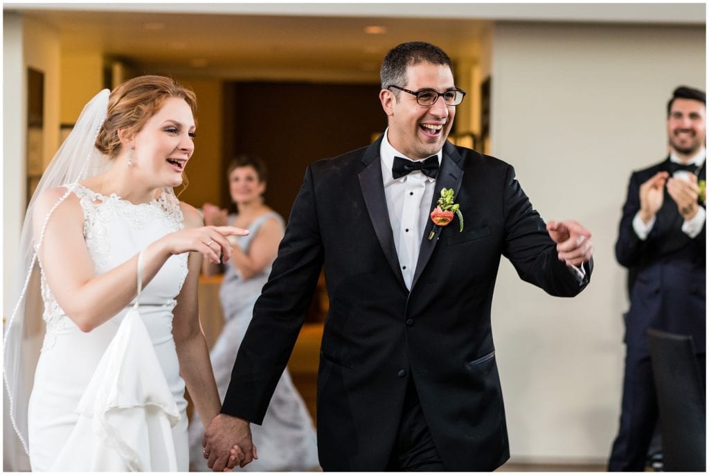 bride and groom being announced into their wedding reception