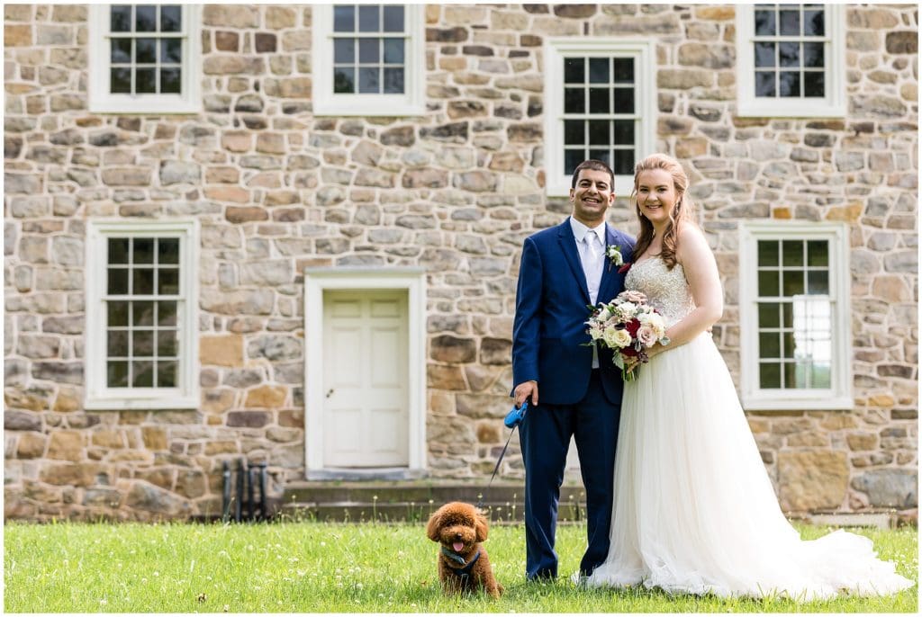 bride and groom with their dog on wedding day at Valley Forge Park