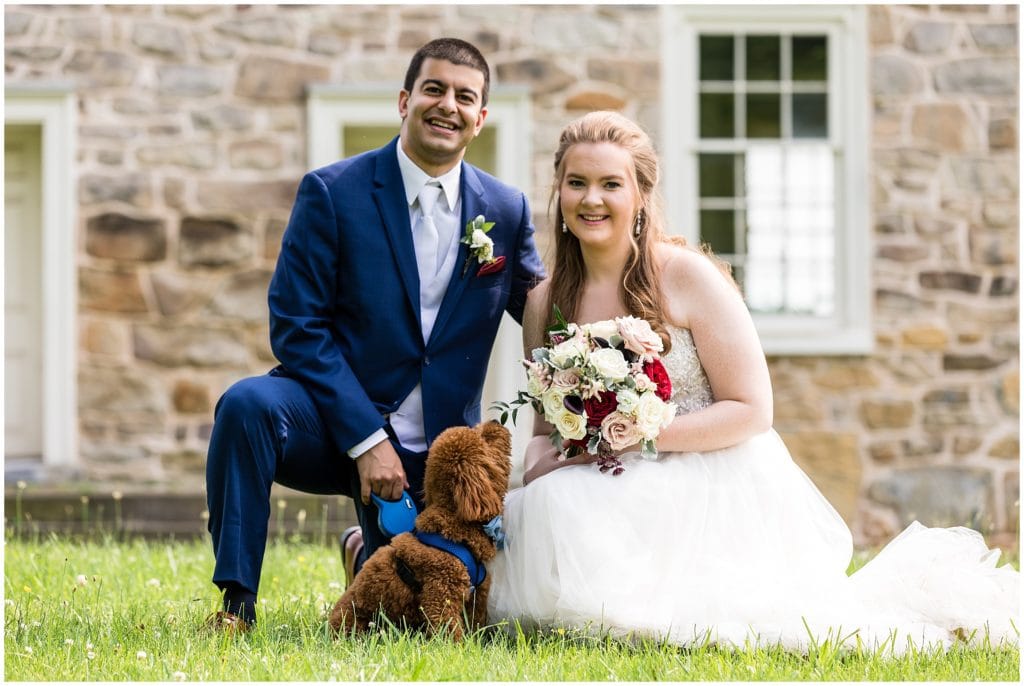 romantic family photo with bride, groom, and their dog on their wedding day
