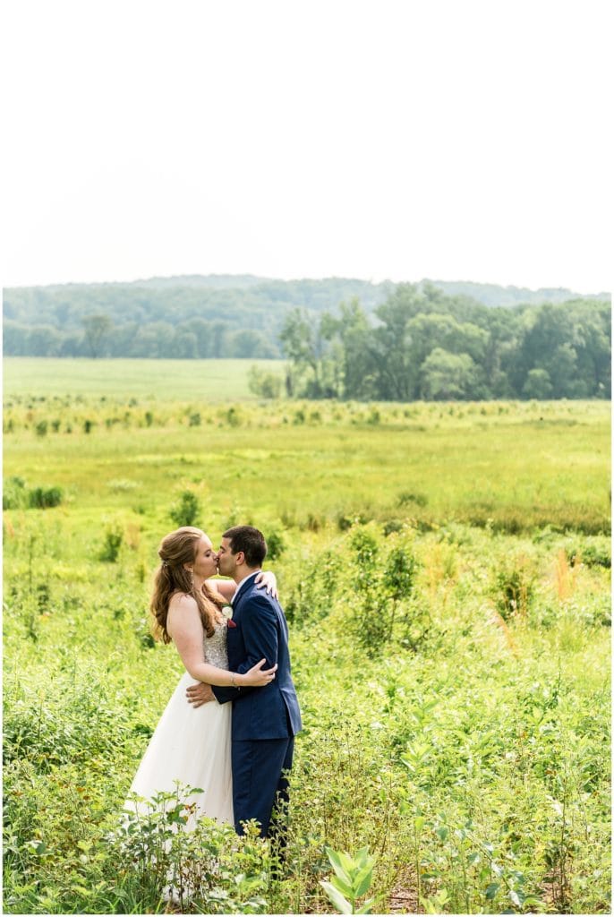 National Park wedding bride and groom kissing in Valley Forge greens