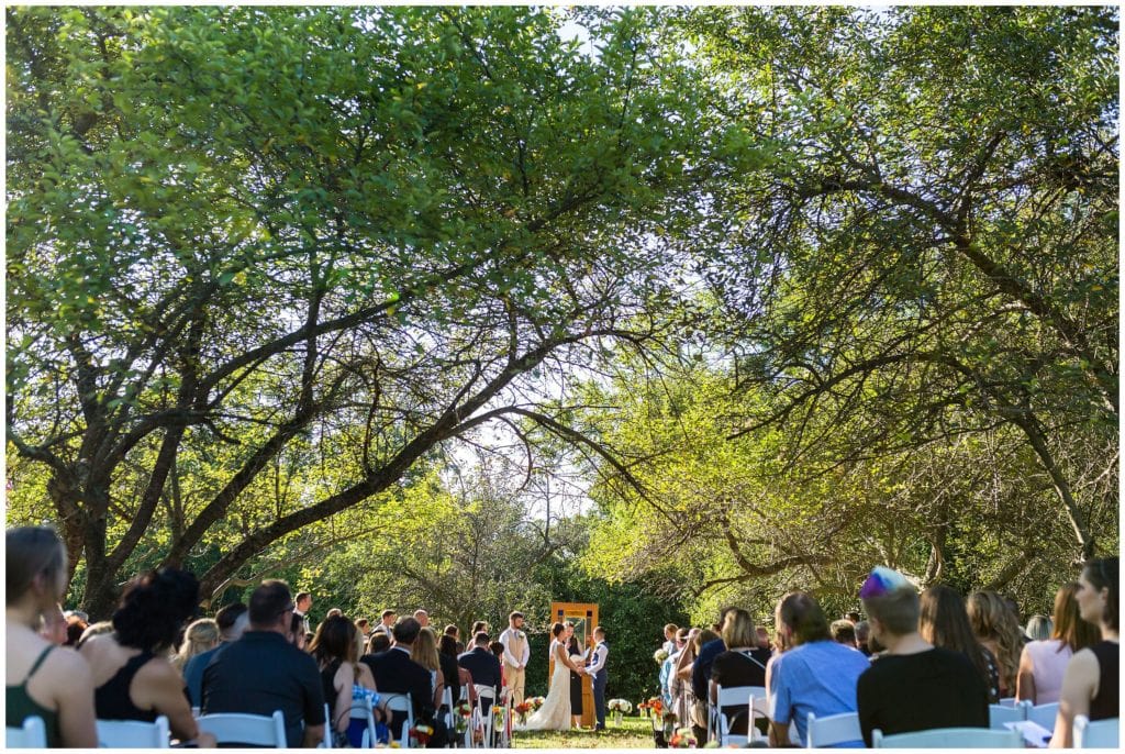 Outdoor wedding ceremony with unique wooden door alter