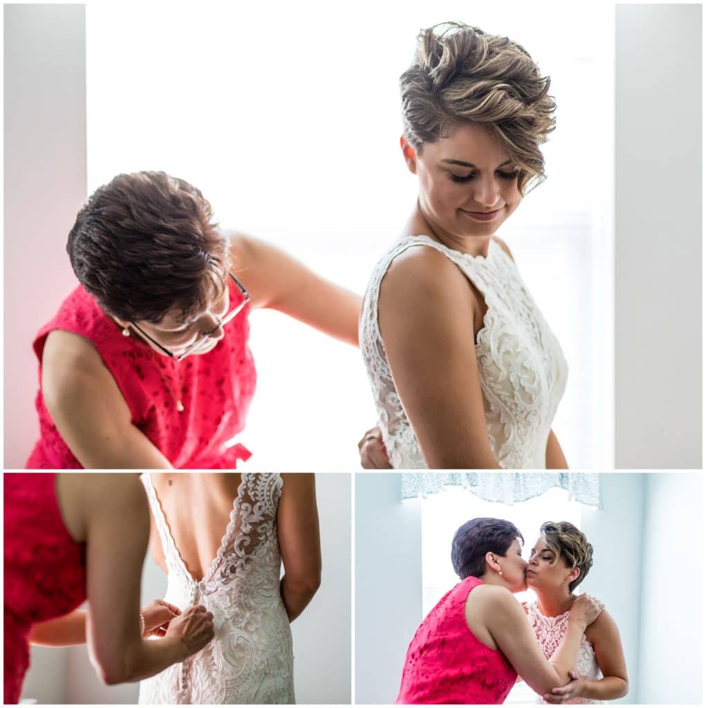 Bride getting ready and into her dress with the help of her mother