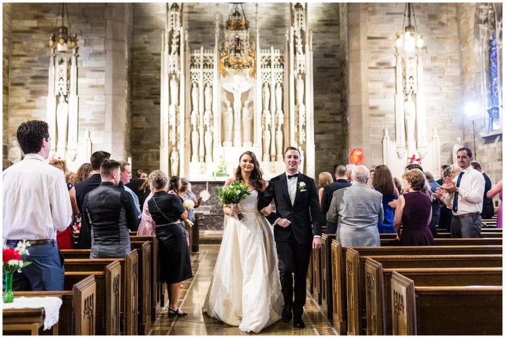 Bride and groom recessing from their ceremony at Holy Cross Catholic Church