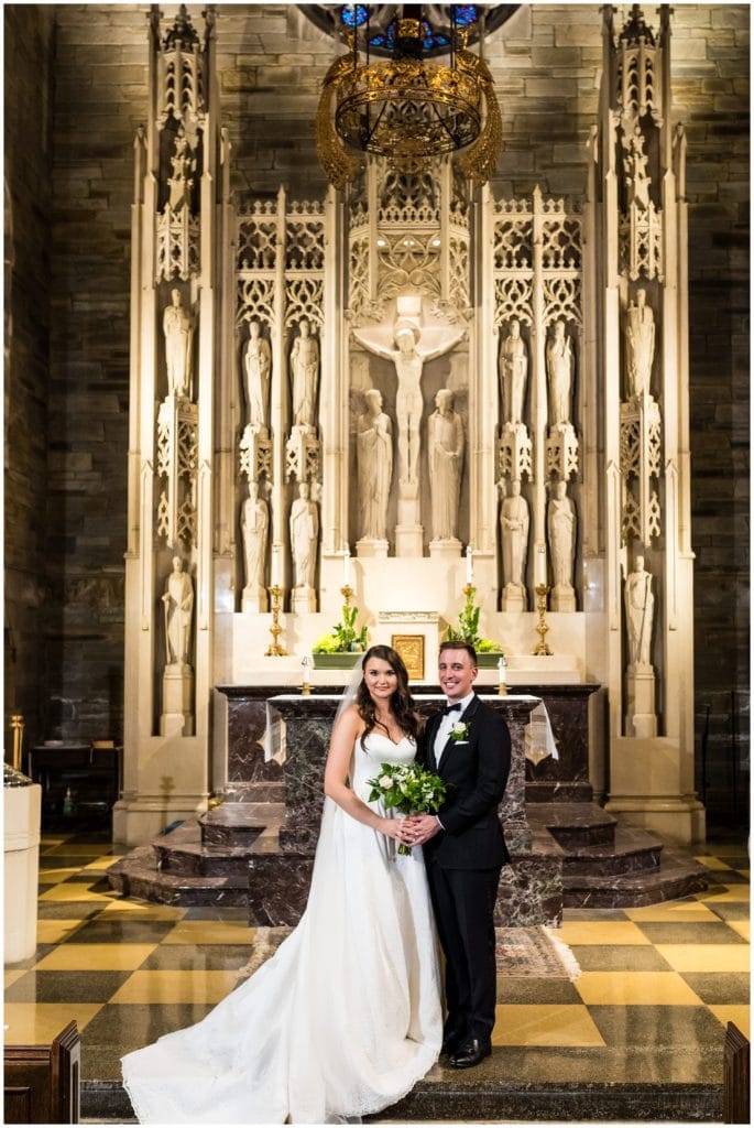 Traditional wedding portrait of bride and groom in Holy Cross Catholic Church