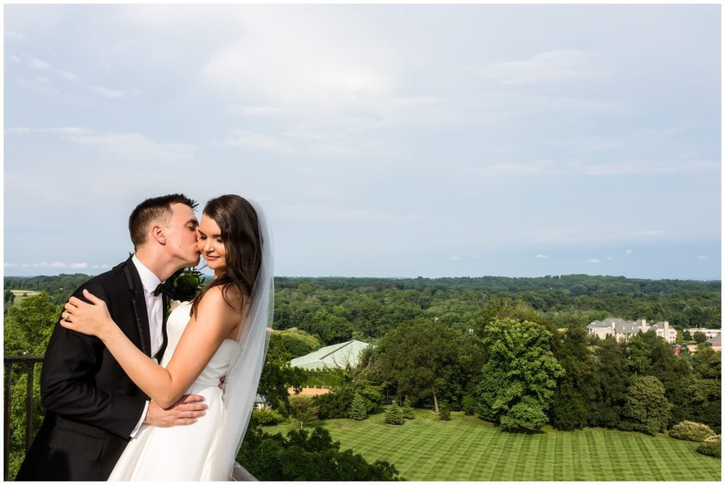 Bride and groom portrait with a view from tower at Cairnwood Estate
