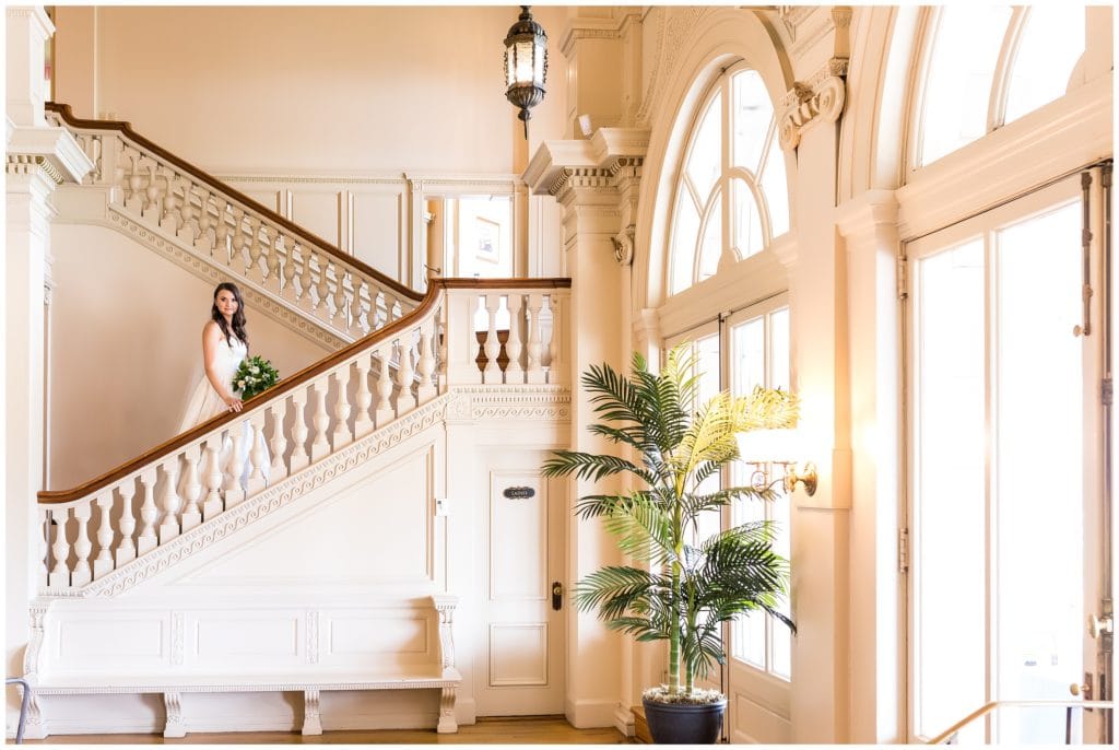 Bridal portrait, bride on grand staircase at Cairnwood Estate