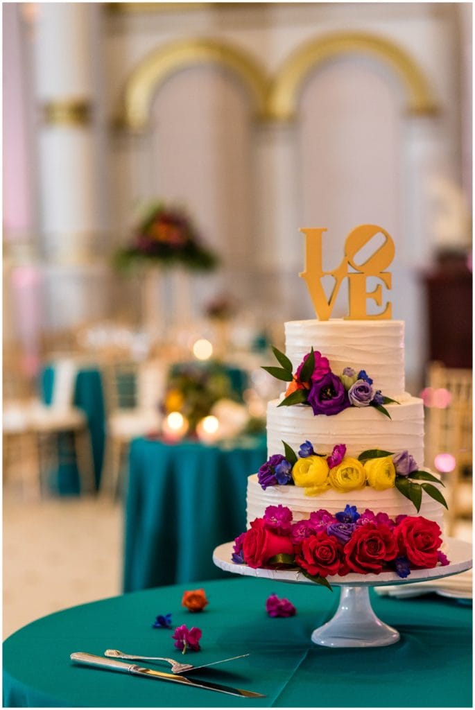 Colorful floral wedding cake with Philadelphia LOVE cake topper