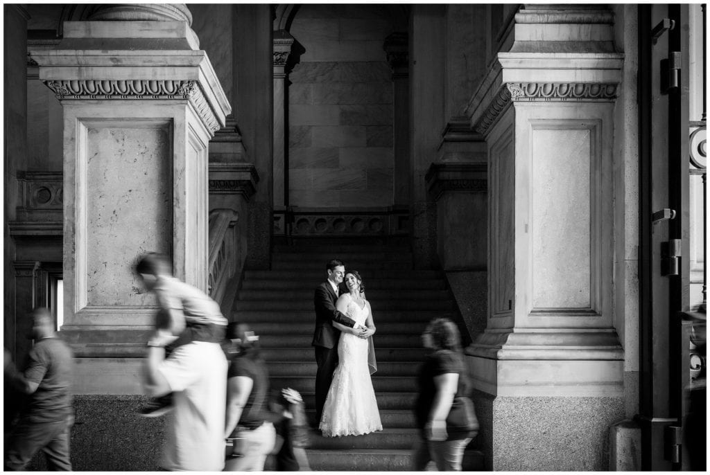 Black and white wedding portrait bride and groom embracing in tunnels at Philadelphia City Hall with motion blur