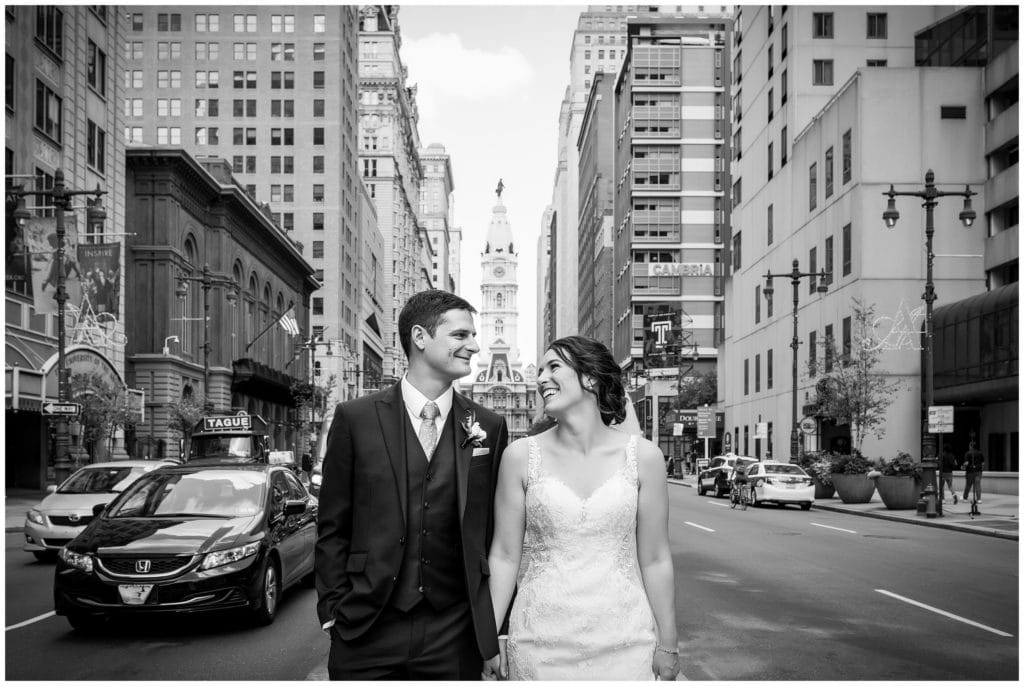 black and white bride and groom portrait in front of Philadelphia city hall on Broad Street