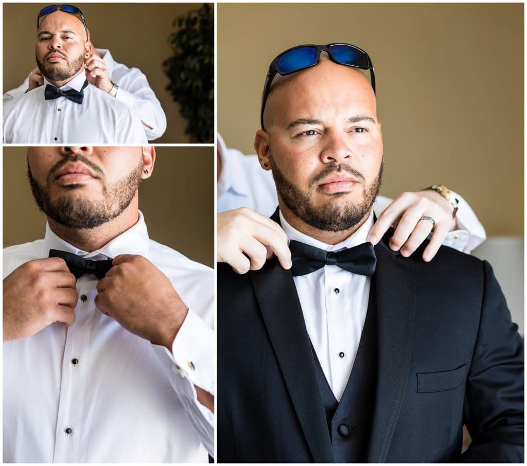 Traditional window lit groom portrait, groom getting help tying his tie