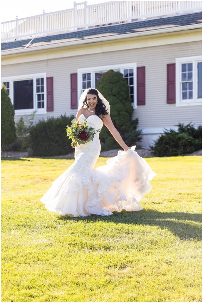 Bride spinning and dancing in her lace mermaid wedding gown at Brookside Country Club