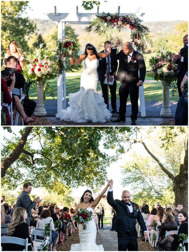 Bride and groom throw hands up and cheer walking up aisle in outdoor wedding ceremony at Brookside Country Club
