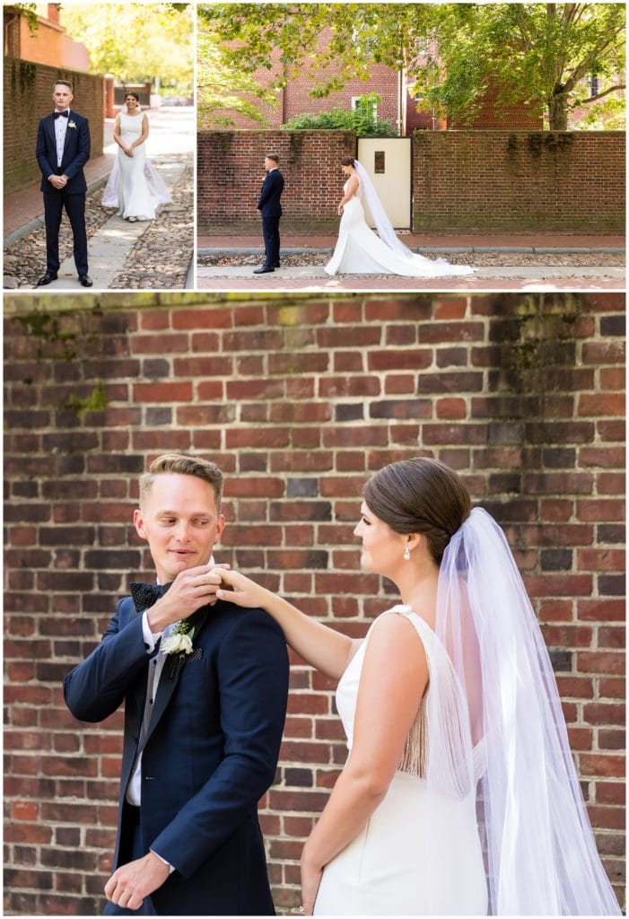 First look in Old City Philadelphia with bride walking up behind groom