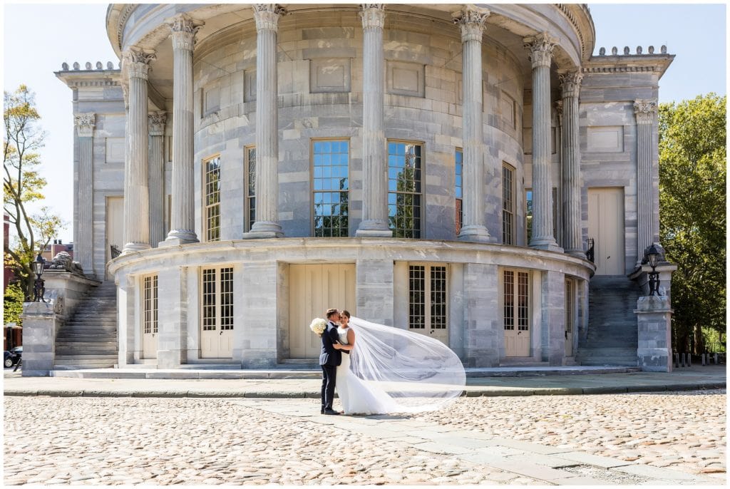 Bride and groom portrait with long veil flowing in the wind in Old City Philadelphia
