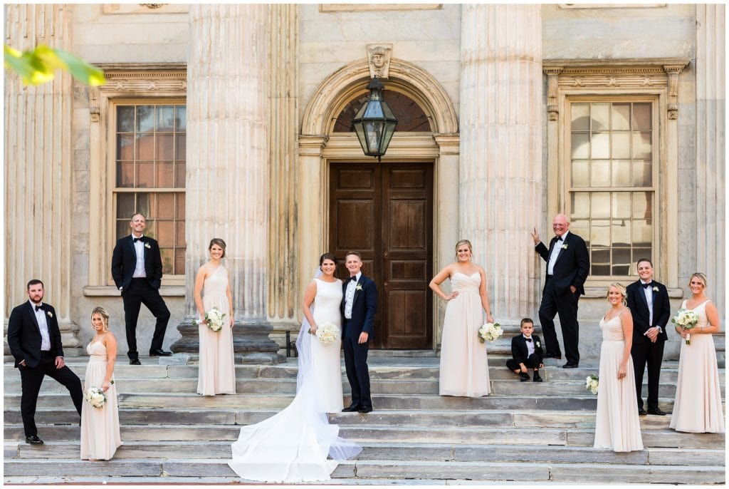Dramatic wedding party portrait spread out on stairs at Second National Bank