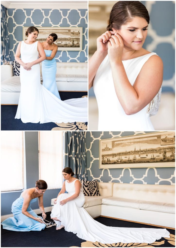 Mother of the bride helping bride into her dress and shoes and bride putting on earrings