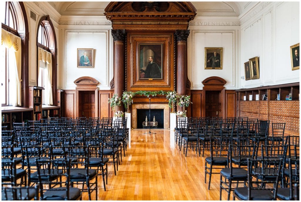 inside College of Physicians set up for a wedding ceremony in front of fireplace - best Philadelphia wedding venues